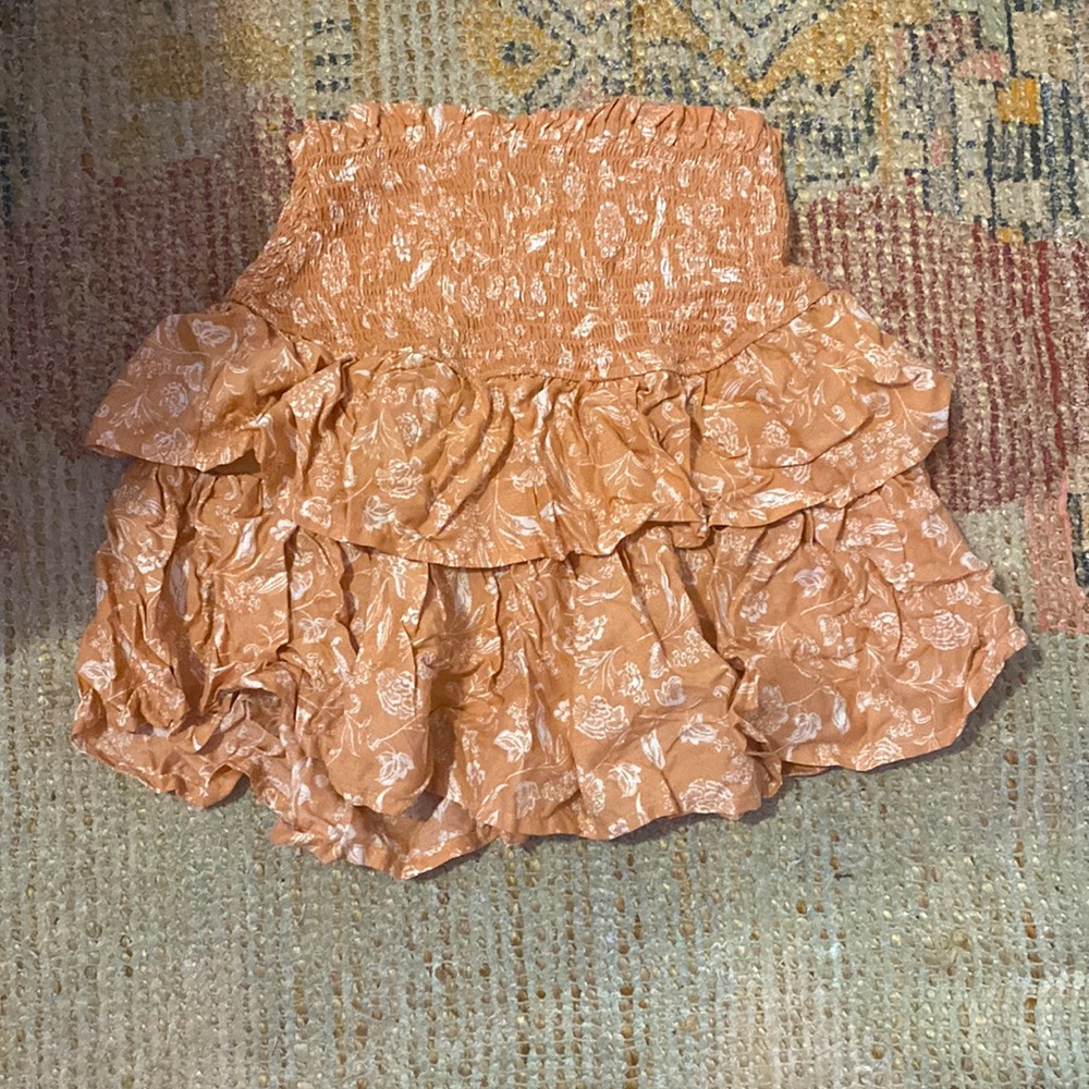 Skirt, it is a coral color with white flowers